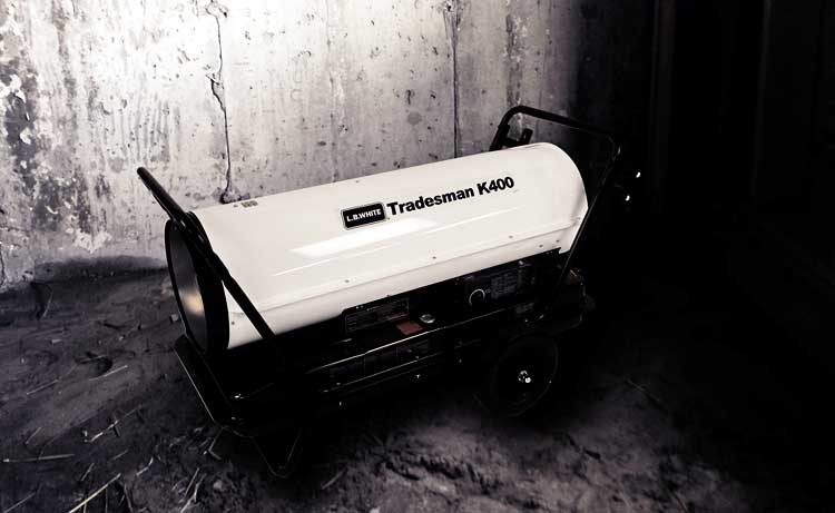 Tradesman K portable kerosene heater warming a building construction site.